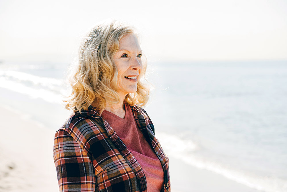 active seniors enjoying the walk on the beach of california